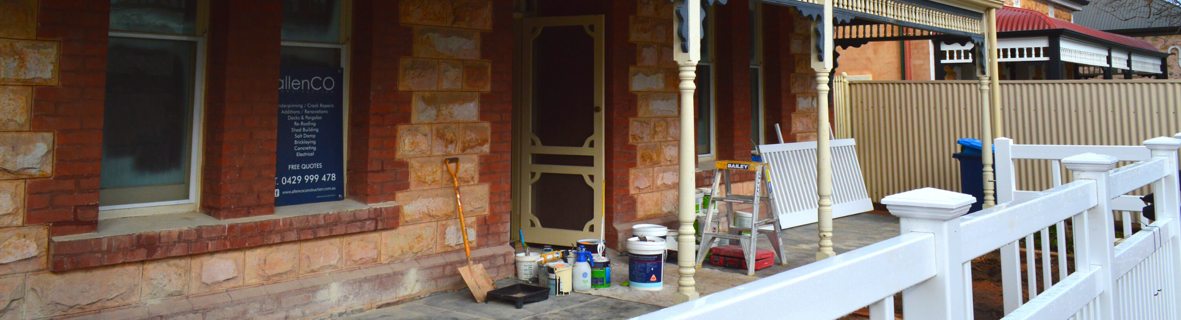 House being renovated, there are paint tins and tools on the fronch porch