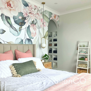 Bedroom with floral wallpaper, gold pendant lights, and designer quilt set