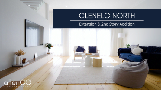 Beautiful white open plan family room with wall mounted tv, couches, and a staircase - allenCO construction