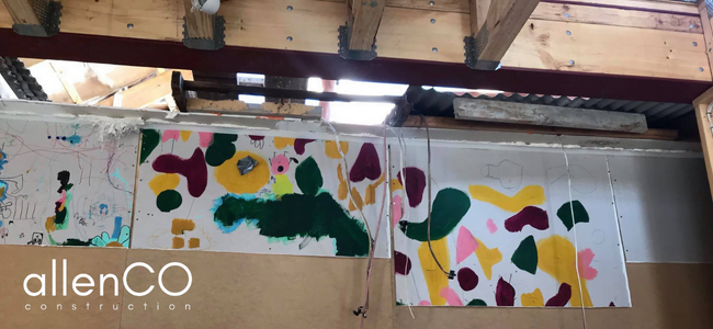 Kids painted artwork on a wall of a house under construction