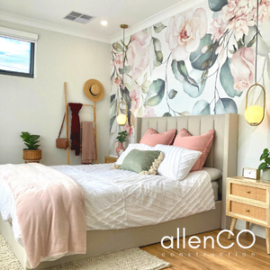 Bedroom with floral wallpaper, gold pendant lights, and designer quilt set