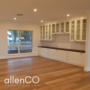 New timber flooring and cabinetry in an open plan living room.
