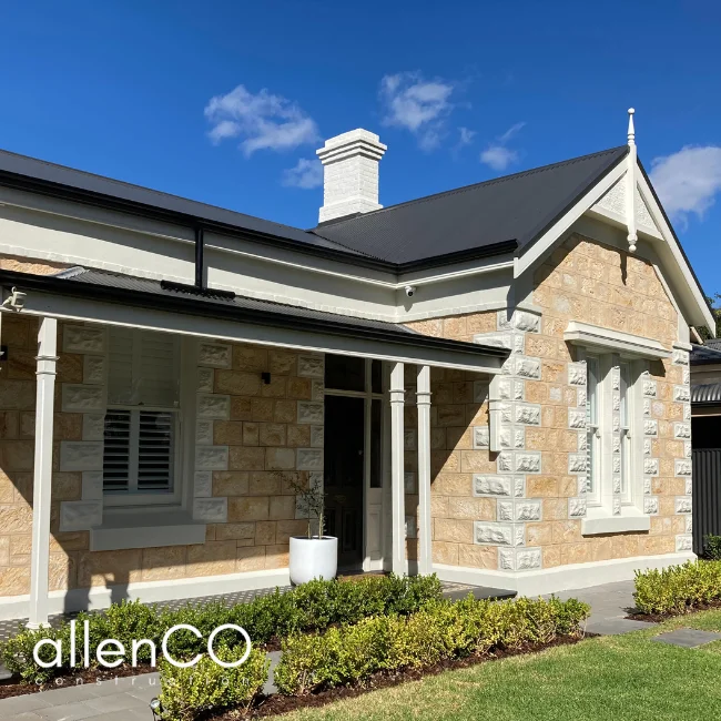 Heritage home with sandstone facade and landscaped garden