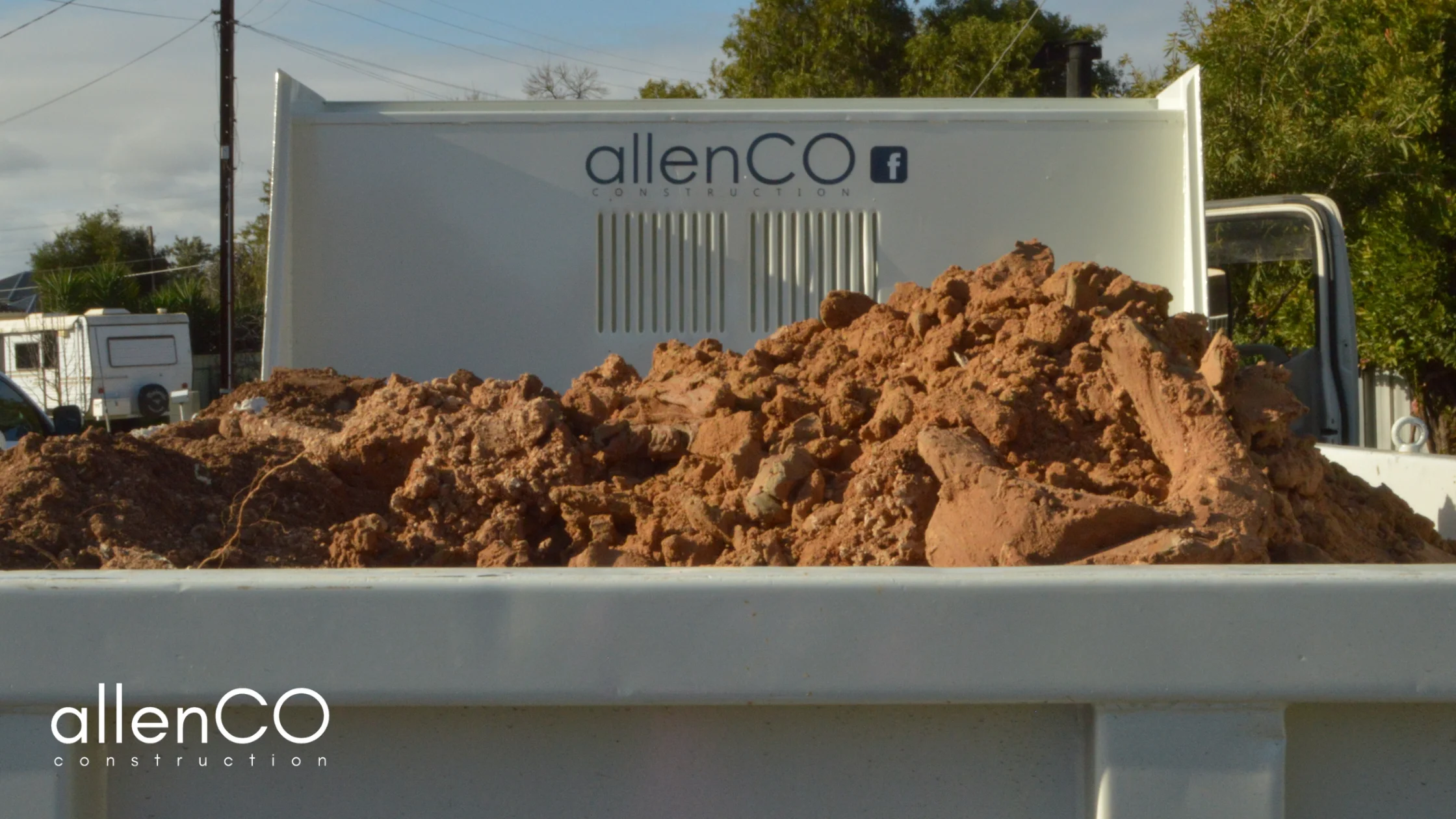 A pile of soil in the back of a white truck