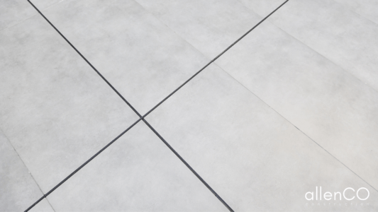 Close up of grey porcelaine floor tiles.
