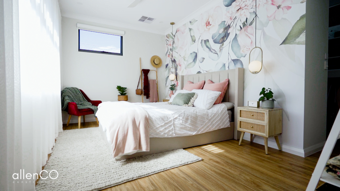 Newly built modern main bedroom with floral wallpaper feature wall.